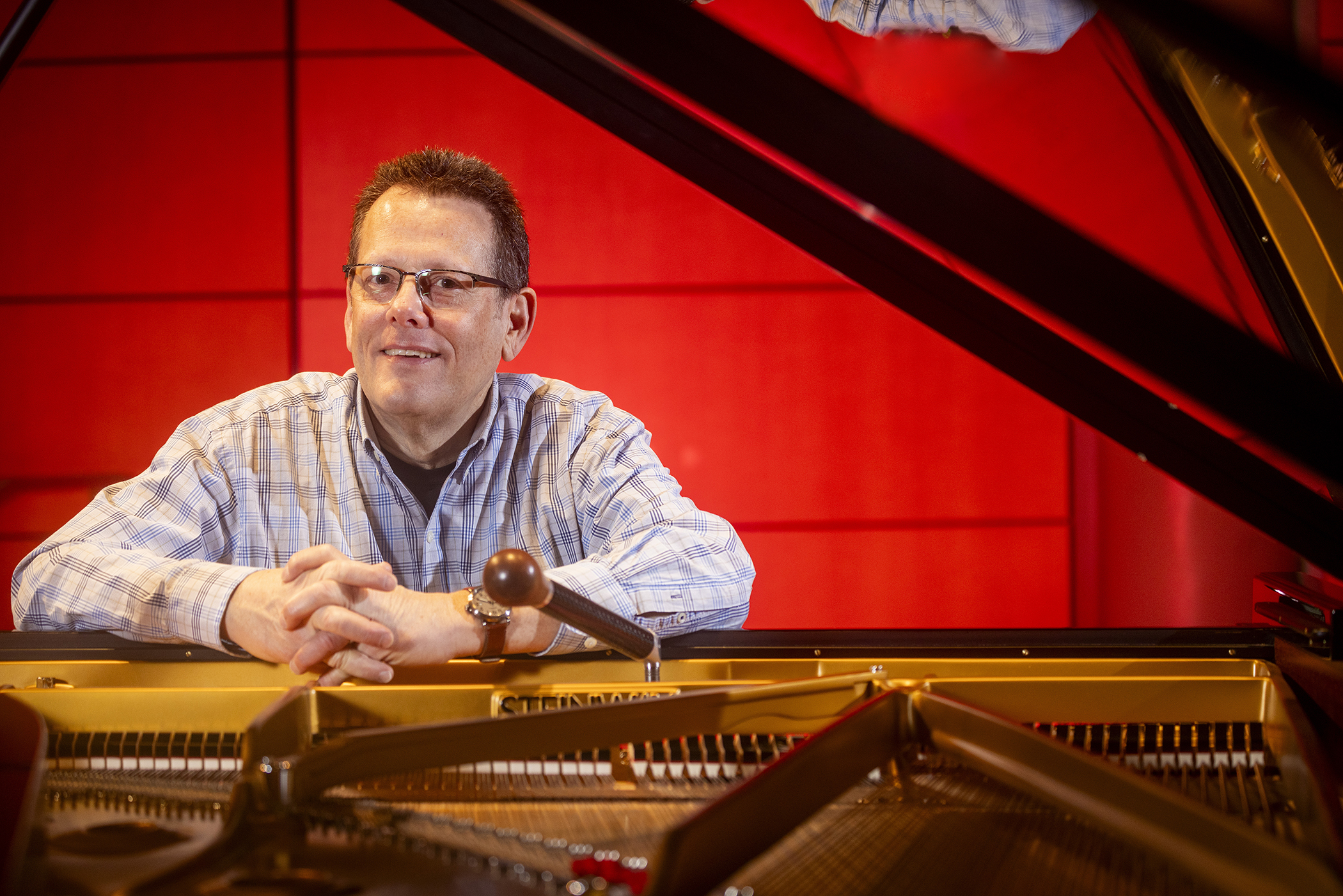 Scott Higgins, lead piano technician at the Hugh Hodgson School of Music, tunes a Steinway grand piano in the Performing Arts Center.